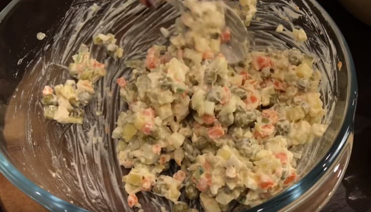 Овкусяваме нашия Оливие с майонеза и разбъркваме добре.