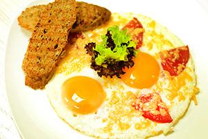 Huevos fritos con tomate y queso.