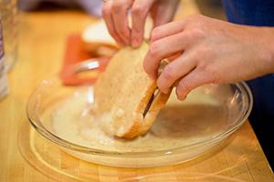 Empape cuidadosamente el futuro crutón en la mezcla de huevo y leche