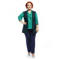 Una blusa verde y un chaleco a cuadros combinan bien con el cabello rojo