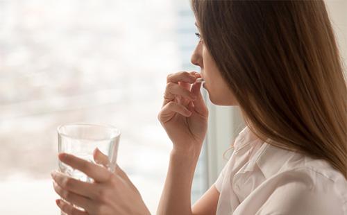 Babae na kumukuha ng gamot