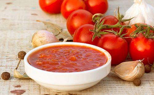 Homemade adjika in a white bowl