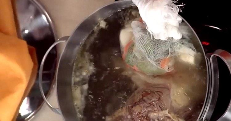 Pregătim legumele și rădăcinile preparate într-un sac de tifon și trimitem la tigaie.