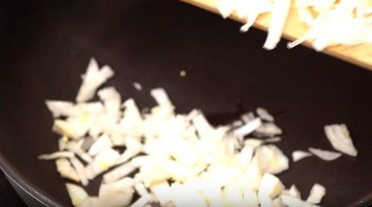 Zwiebeln in einer Pfanne mit Pflanzenöl anbraten.