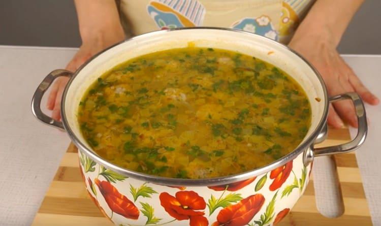 Al final de la cocción, agregue verduras picadas a nuestra sopa con albóndigas y arroz.