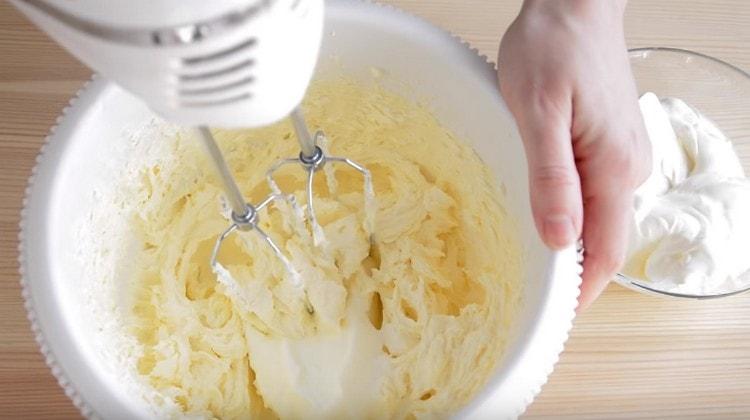 V částech zavádíme zakysanou smetanu do olejové hmoty.