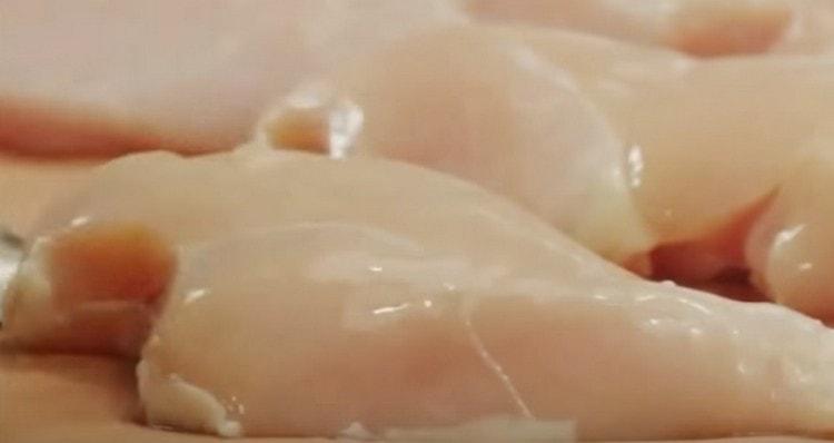 Измийте пилешкото филе и го нарежете наполовина.