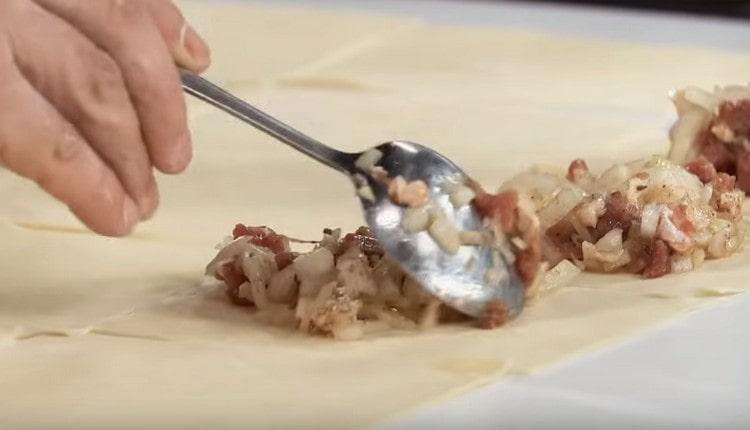 Legen Sie die Füllung in die Mitte jedes Quadrats des Teigs.