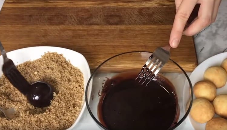 Dip each cookie into the icing. and then roll in crushed nuts.