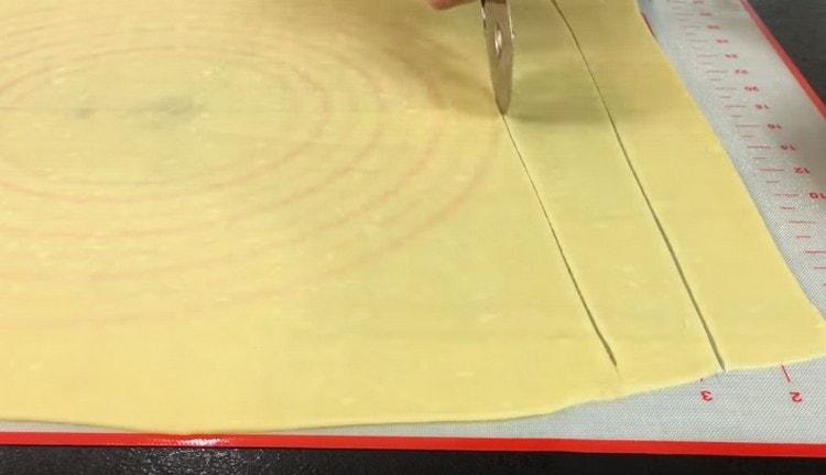 Cortar la masa enrollada en tiras de igual ancho.