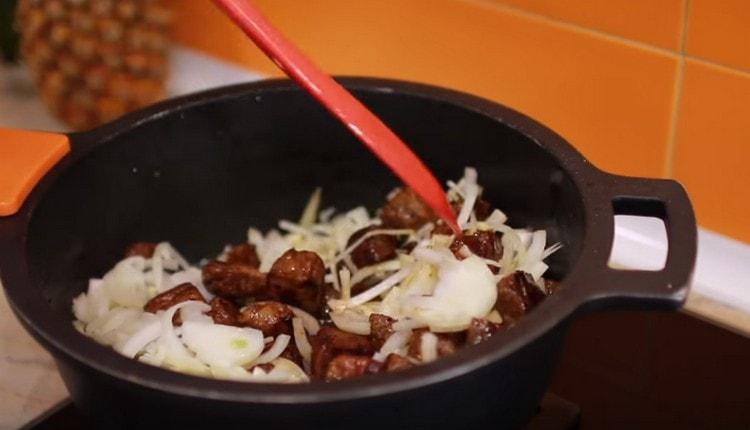 Pon las cebollas en el caldero para la carne.