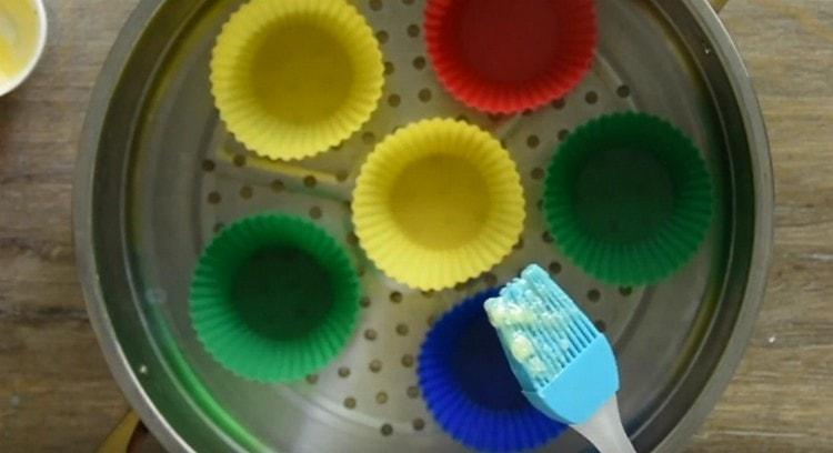 Engrase los moldes de silicona con mantequilla derretida.