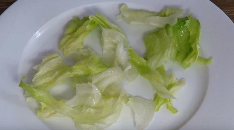 Coloque a salada de iceberg em uma travessa grande.