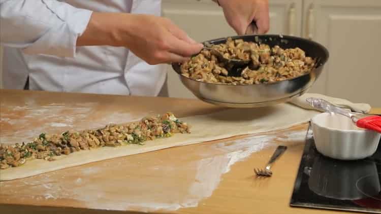 Pentru a face o plăcintă cu pui și ciuperci, puneți carne tocată pe aluat