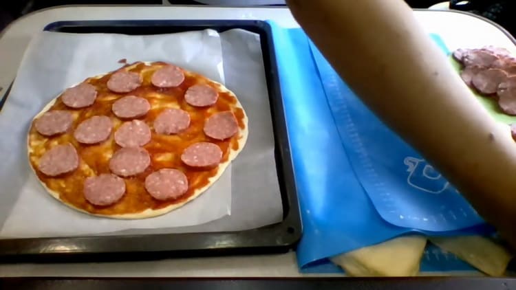 For at tilberede pizza på kefir i ovnen skal du skære pølsen