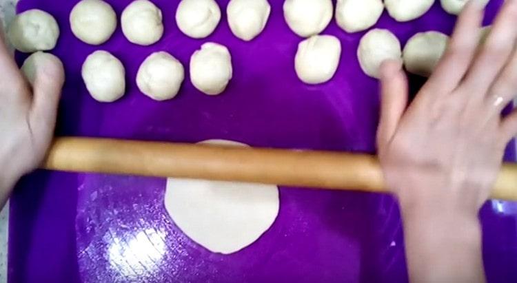 Разделете тестото на парчета и ги разточете с точилка.