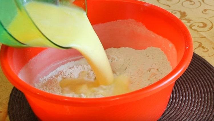 Introduce the liquid components into the flour with yeast.