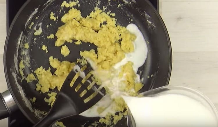 Adăugați puțin laptele la făina preparată.