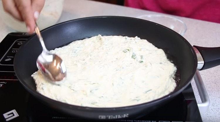 Distribuim jumătate din aluat într-o tigaie unsă cu ulei vegetal.