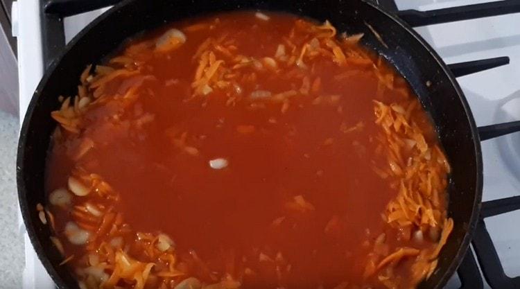 Adăugați sucul de roșii amestecat cu apă în legume.