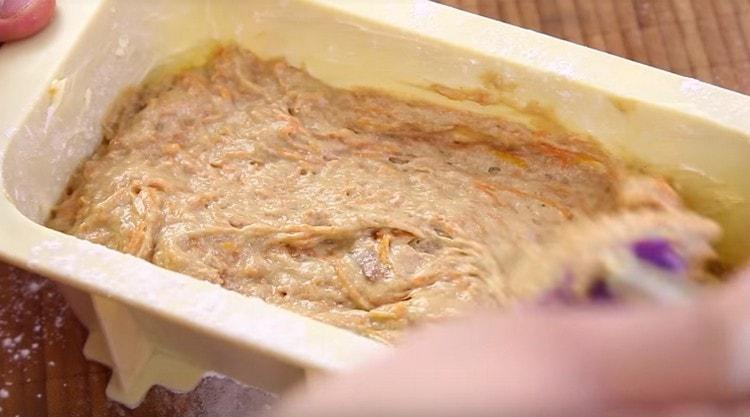 We shift the dough into a form, level it with a spatula.