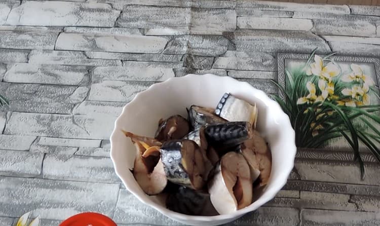 We clean the mackerel, gut it, cut it into pieces.