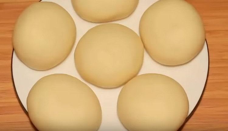 Estirar una bola de cada pedazo de masa, ponerlos en un plato y enviarlos al refrigerador.
