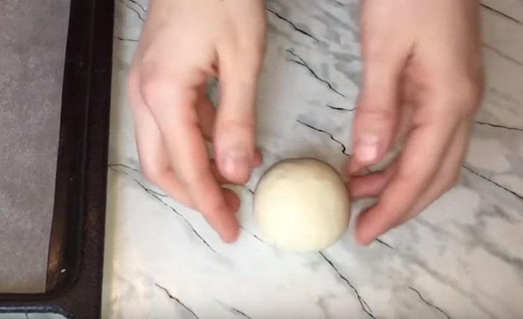 We roll each piece of dough into a ball.