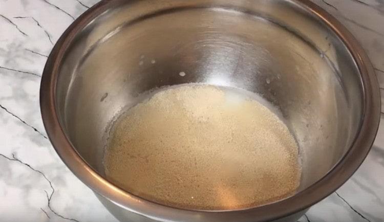 Dissolve yeast with sugar in warm water.