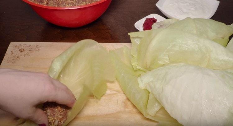 Vi sprider köttfärs på kålbladet.