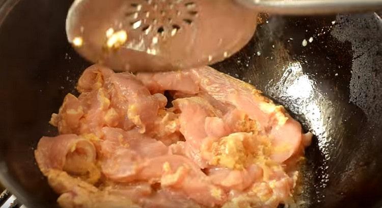 Add chicken fillet to the onion.