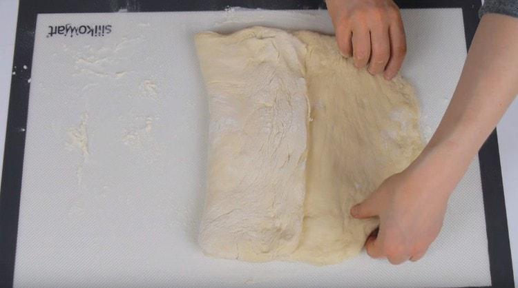 Stretch the dough into a rectangle, and then fold in three.