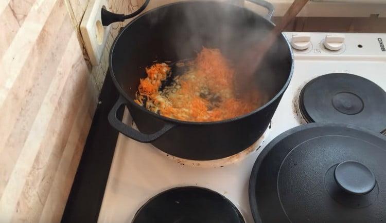 Add carrots to the onion and simmer the vegetables until soft.