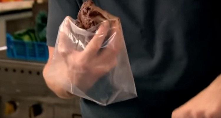 On a hand we put on a pastry bag with a nozzle, put chocolate filling in it.