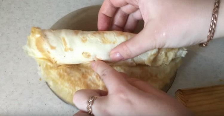 Îndoiți clătitele terminate una deasupra celeilalte și răsuciți ruloul.