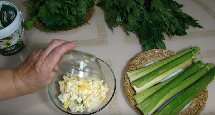 Добавете нарязаните яйца към салатата.