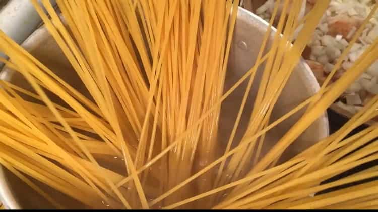 To cook pasta with meatballs, boil noodles