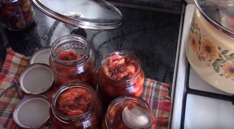 Después de la esterilización, las ciruelas deben transferirse de una lata a otra, ya que están enganchadas.