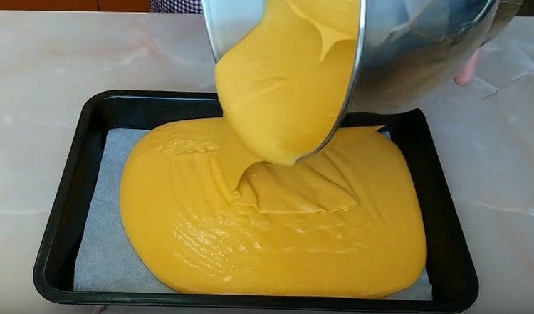 Gießen Sie den Teig auf ein Backblech mit Pergament.