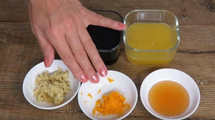 pe o răzătoare, trei felii de portocale și ghimbir.