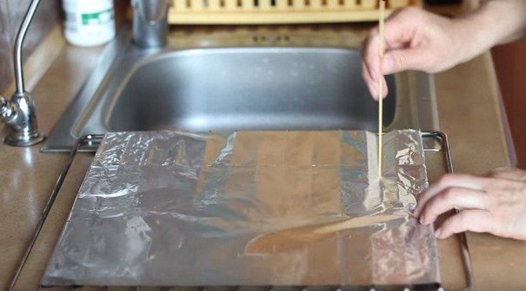 Cover the grate from the oven with foil, pierce it.