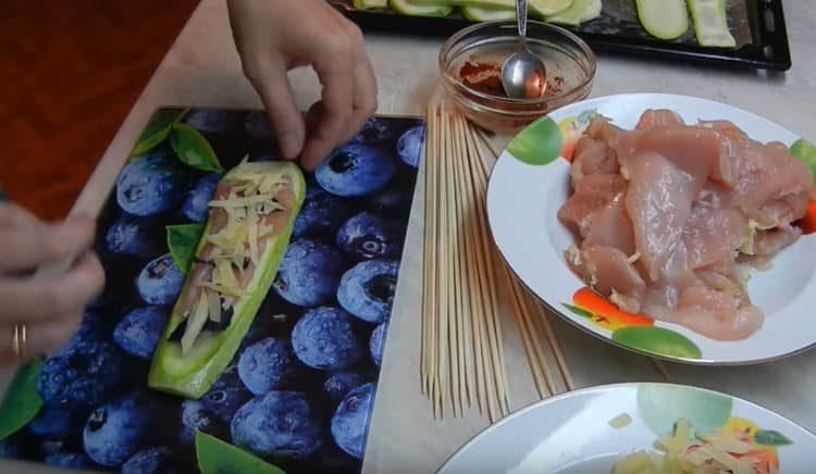 Escampem el pollastre, l’alfàbrega, el formatge en una llesca de carbassó.