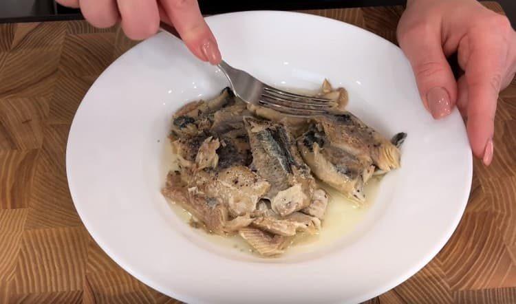 Amasar con un tenedor conservas de sardinas.