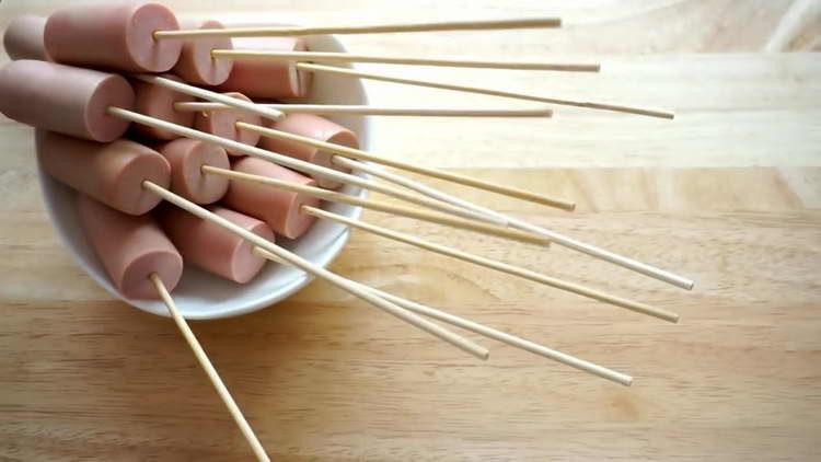 Würstchen auf Spieße legen