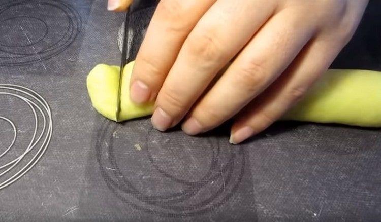 Divide la masa en porciones, enrolla salchichas y córtalas en trozos pequeños.