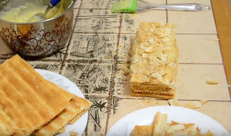 Saupoudrer le gâteau Napoléon fini avec les miettes laissées par le gâteau.
